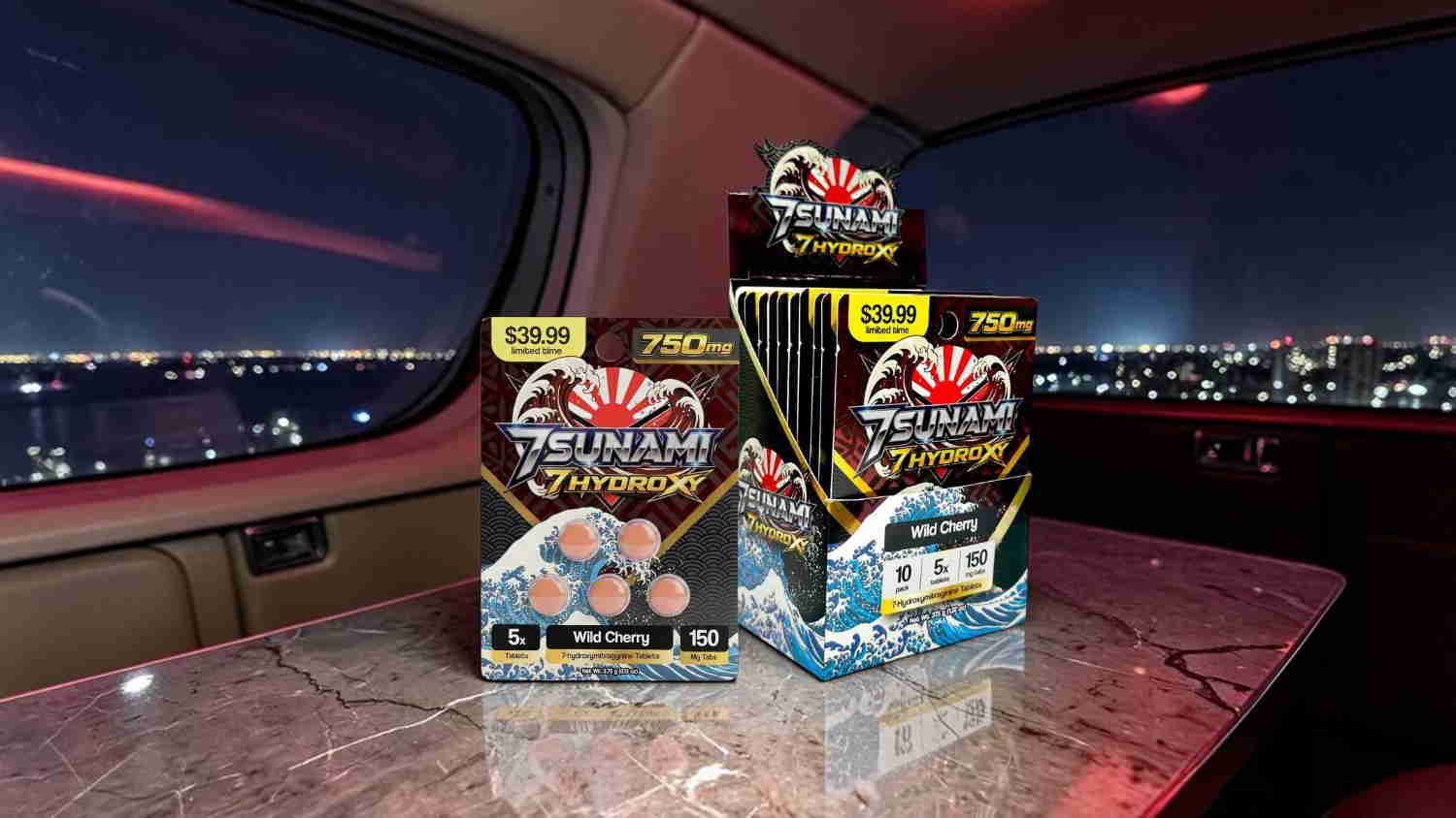 Boxes of products displayed on a table with a city view at night.