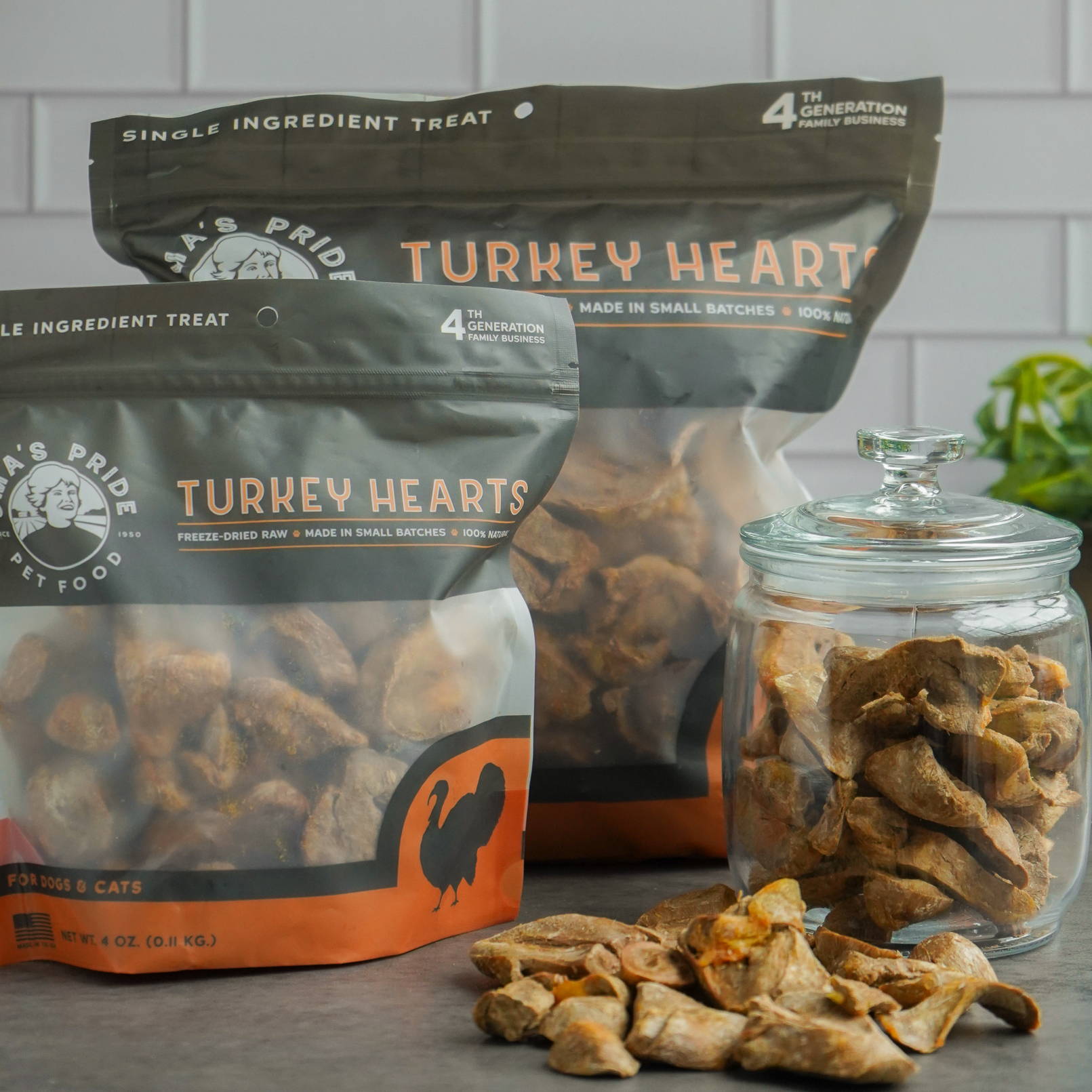 4 oz and 16 oz product bags of sliced turkey hearts on gray counter with clear jar.