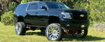 Corey's lifted black 2018 Chevrolet Suburban front three-quarter thumbnail
