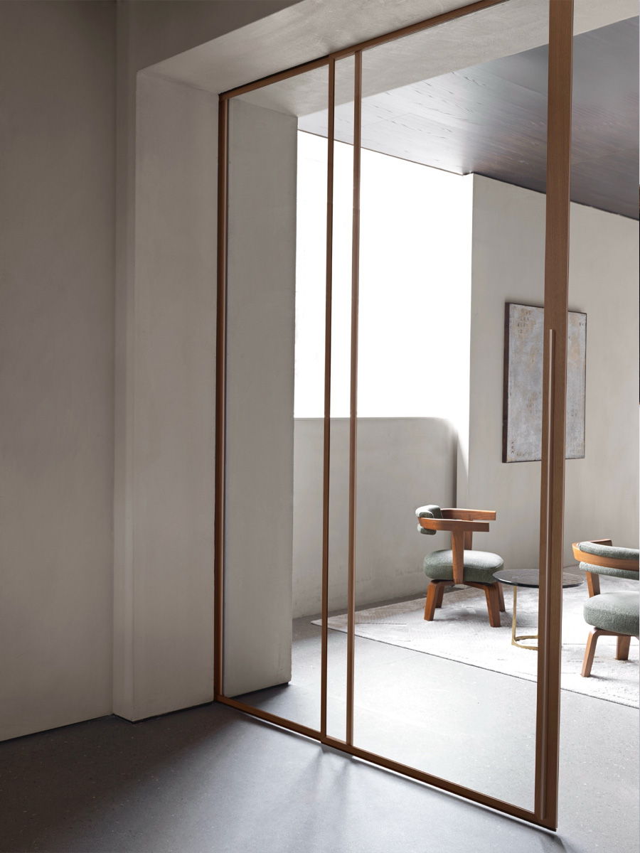 Interior space with glass Molteni doors and minimalist furniture.