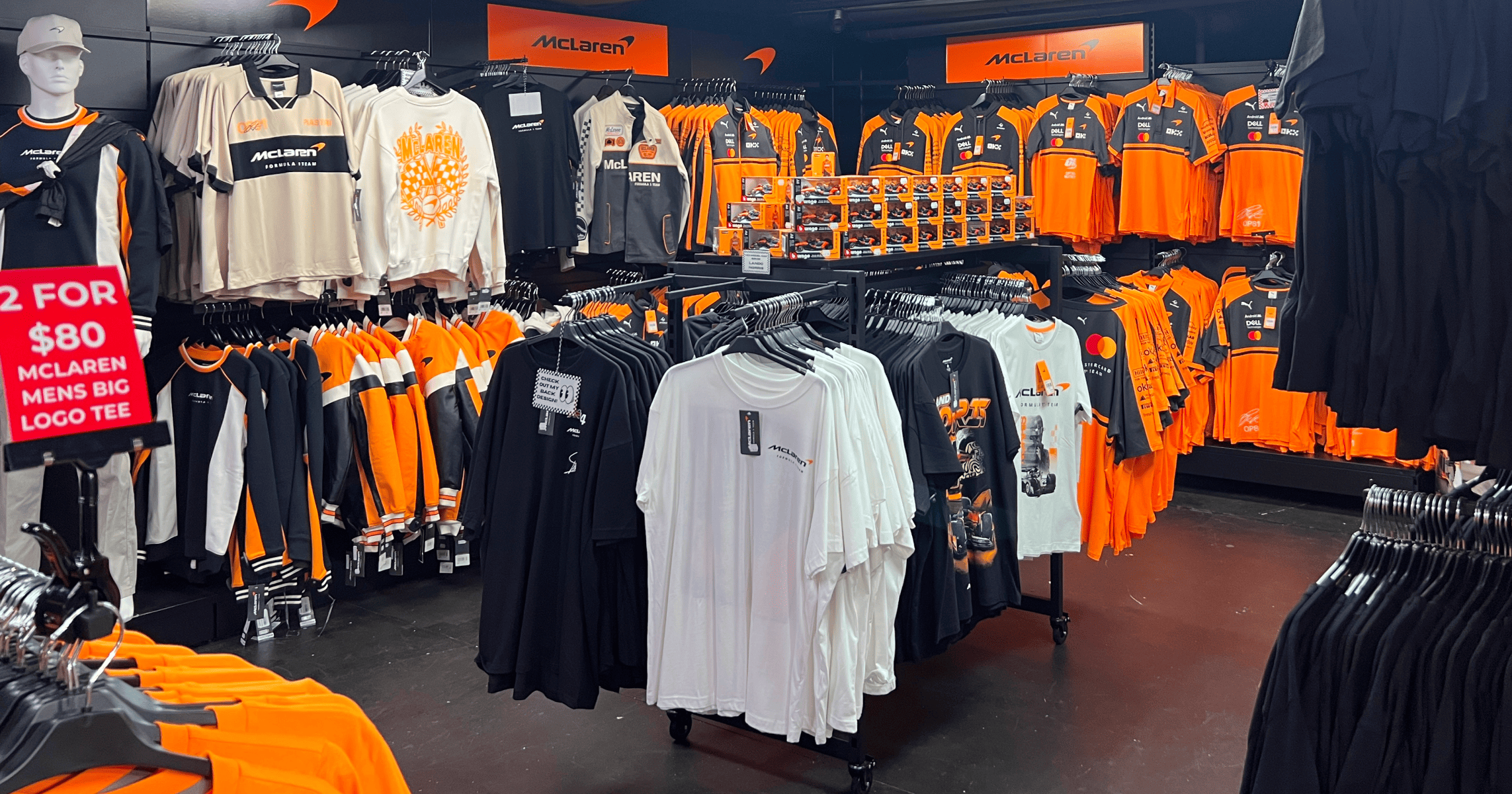 Clothing store display featuring various orange and black apparel.