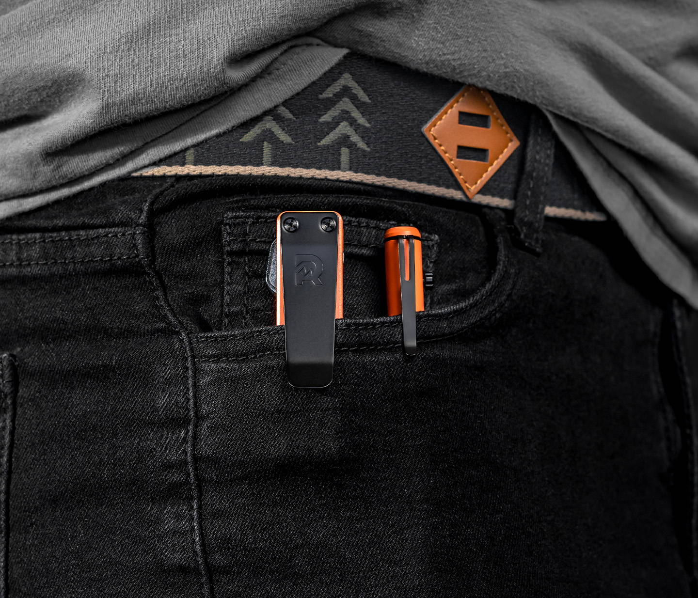 Basecamp Orange Bolt Action pen and keycase clipped on side pocket