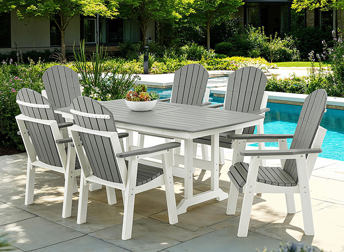 Outdoor dining set by a pool with six chairs and a table.