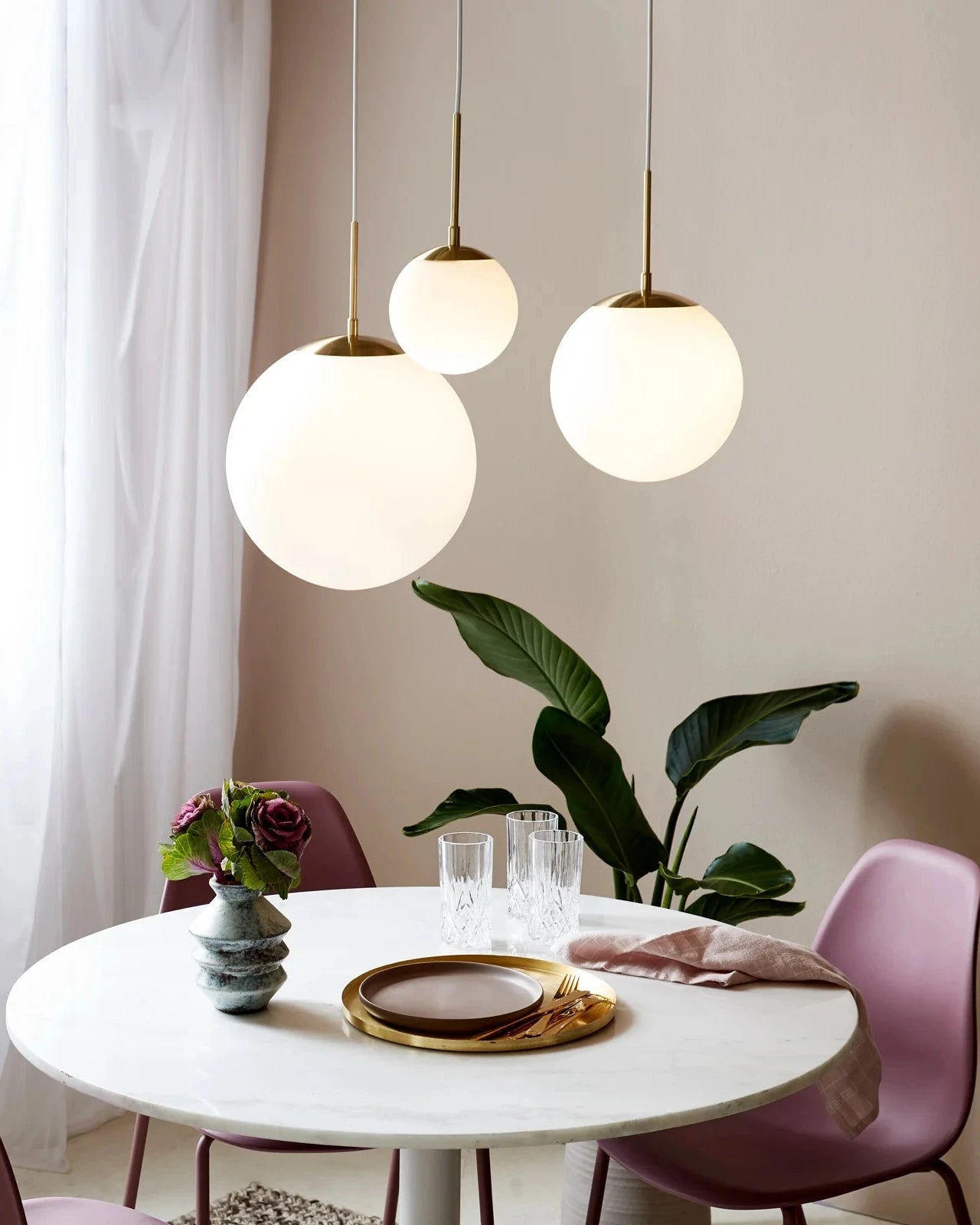 Simplistic Opal Sphere Pendants (Small, Medium & Large) in a Cluster suspended above a Dining table setting - Lighting Collective 