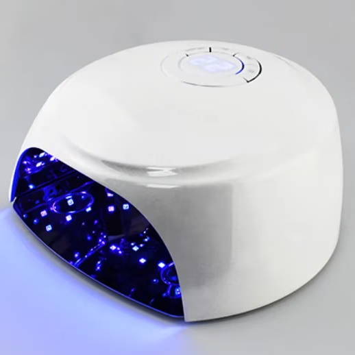 White UV nail lamp with blue light emitting from the front.