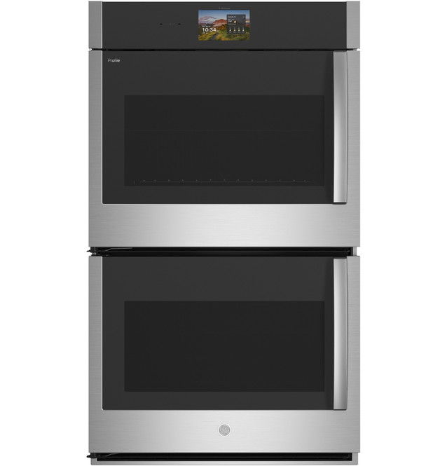 Double oven with stainless steel finish and black glass doors.