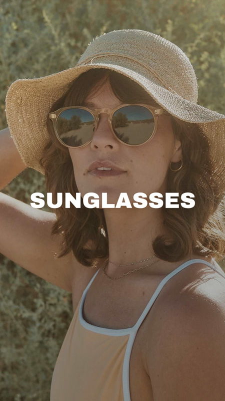 Person wearing sunglasses and a hat, with a natural background.