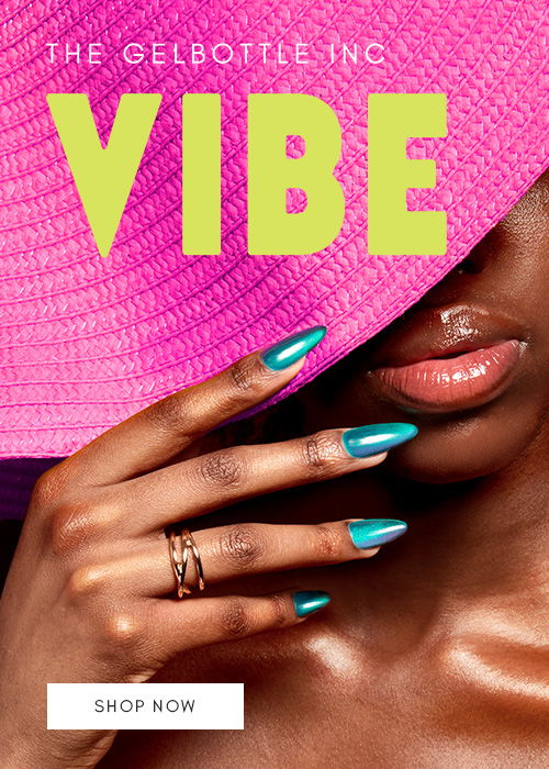 A close-up of a hand with stylish nails, covered by a pink hat.