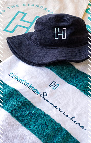 Branded merchandise including bucket hat, cap and towel featuring embroidered 