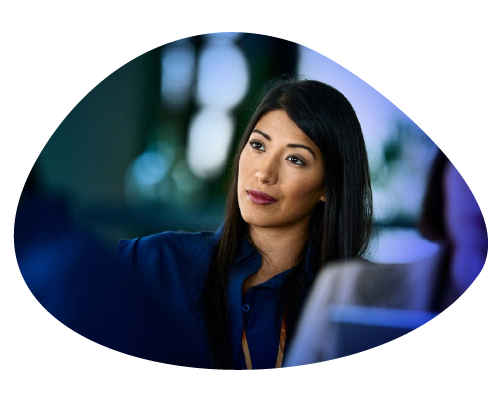 A woman engaging in a discussion, looking thoughtful and attentive.
