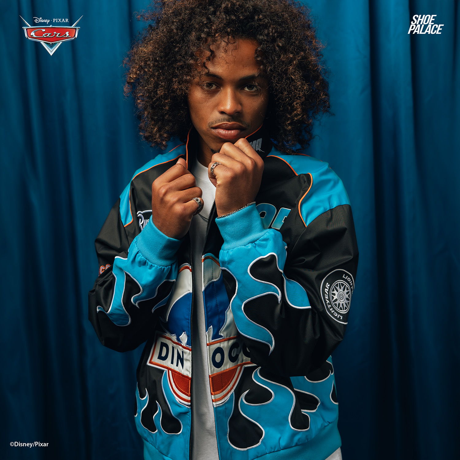 Person wearing a blue camo jacket in front of a blue backdrop.
