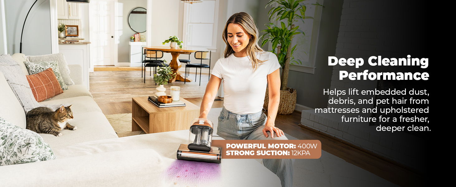 Person vacuuming a living room with a cat nearby, promoting deep cleaning performance.