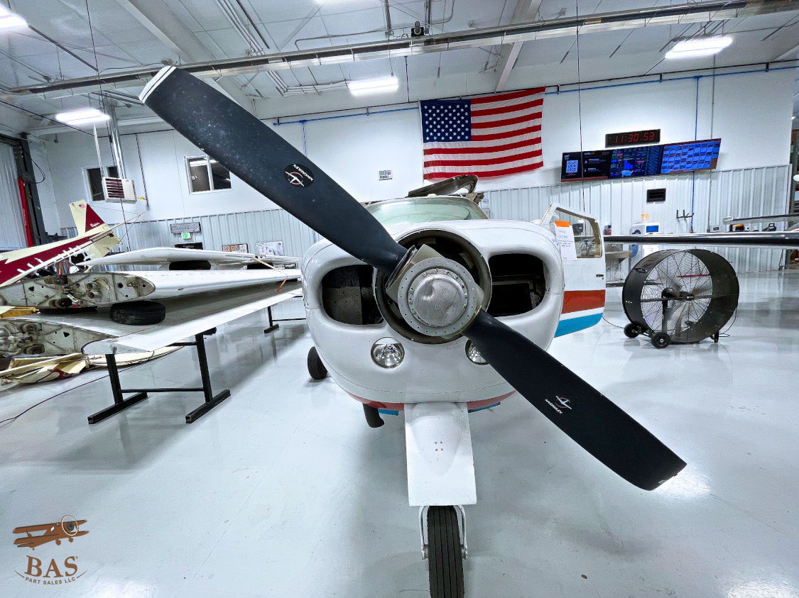 Propeller of a small aircraft in an indoor museum setting.