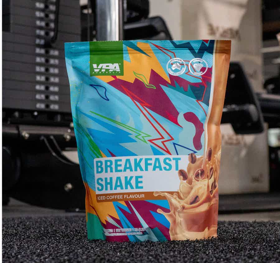 Colorful breakfast shake pouch in a gym setting.