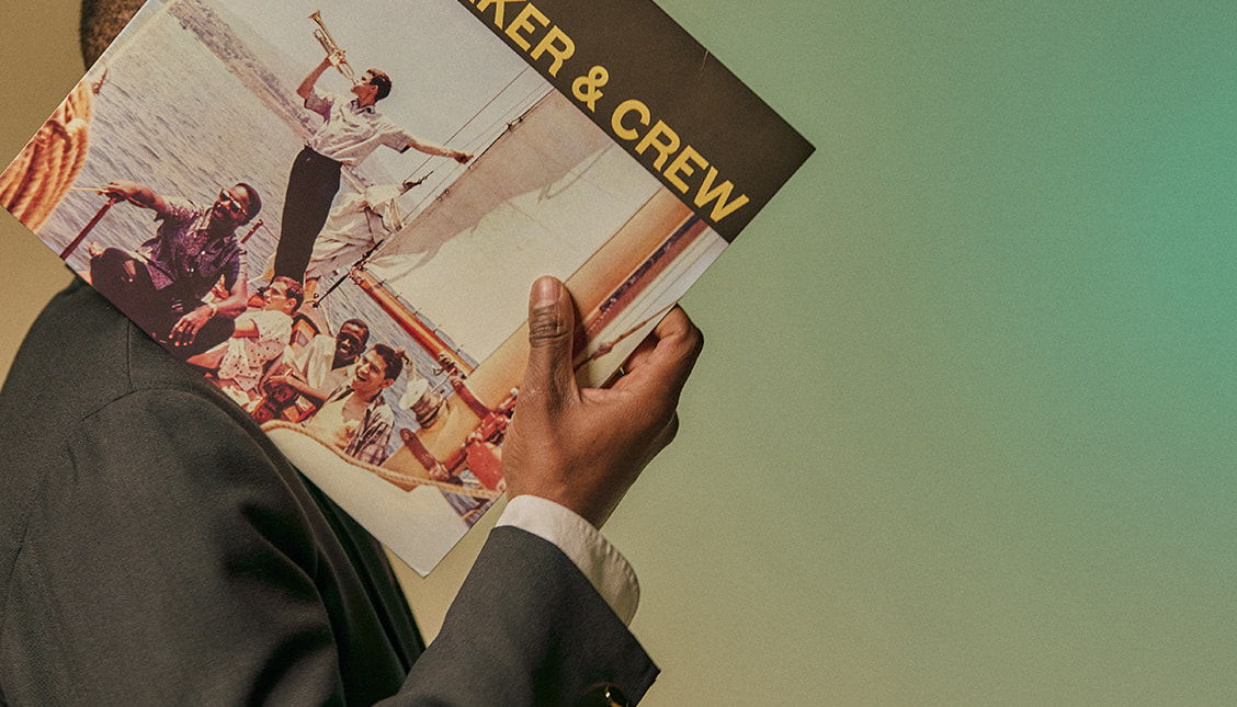 Person holding a vinyl record titled 