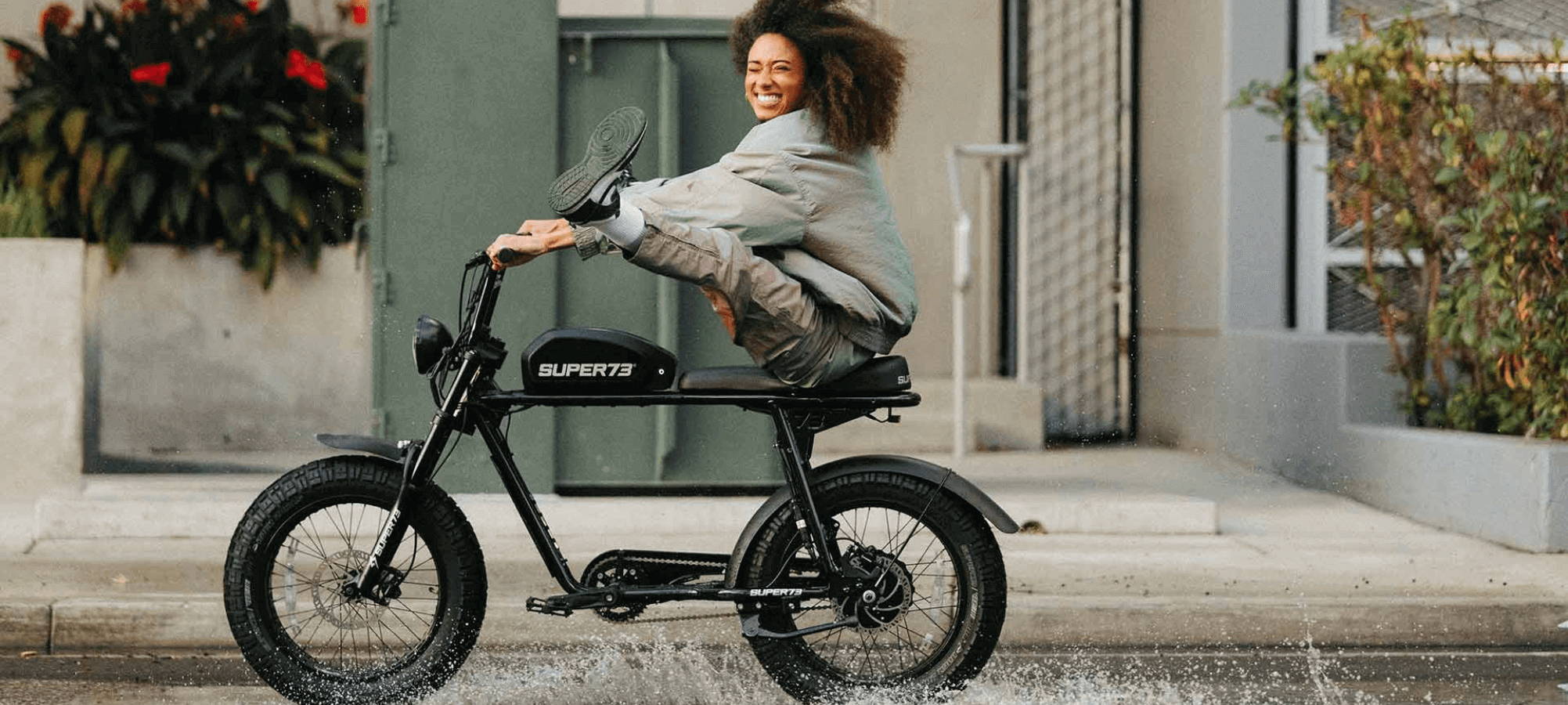 black electric bike with a black power hair girl riding and having fun