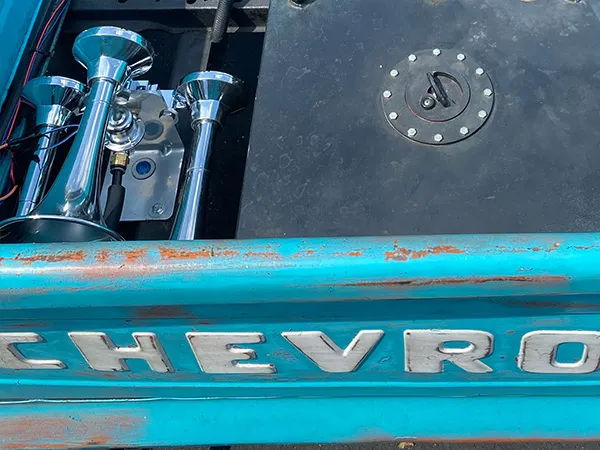 Close-up of the chrome Outlaw horn bells and air tank mounted in the bed of Rob's 1958 Chevrolet Apache, install photo 4