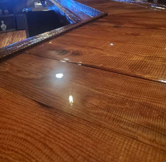 A close-up image of the rustic epoxy bar top with the raised trim. It was made using UltraClear Epoxy.