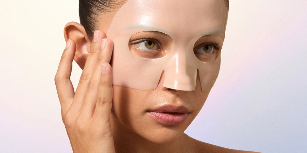 Person applying a facial mask with a serene expression.