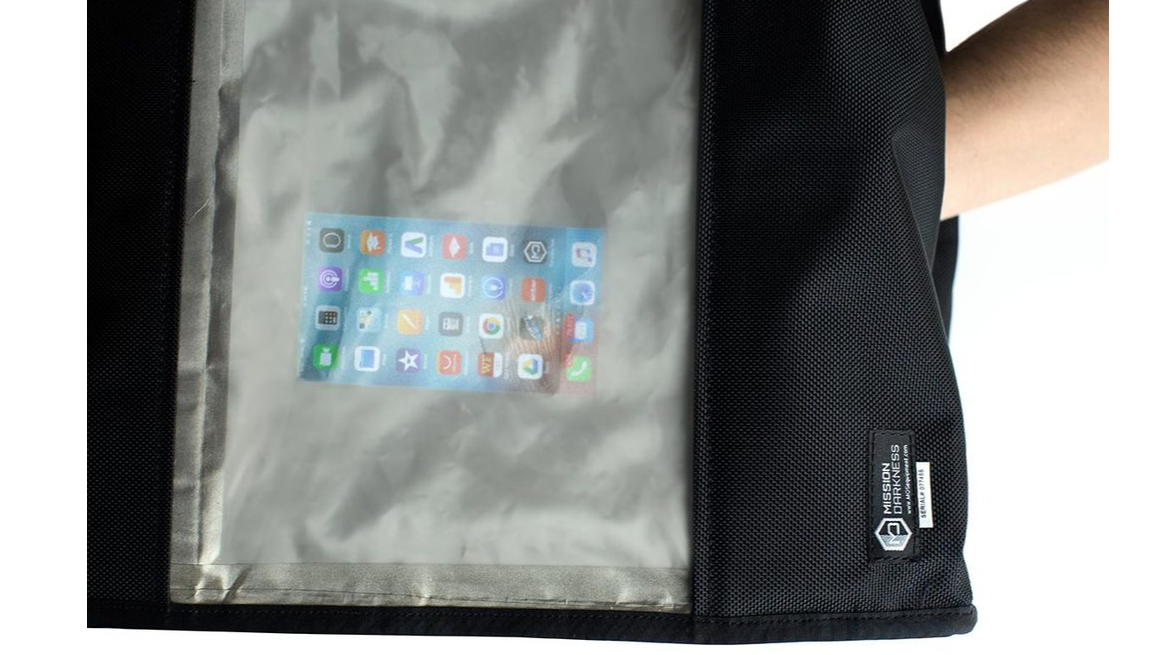 Operating and viewing a device screen through the large shielded transparent window of the Mission Darkness BlockBox Touch