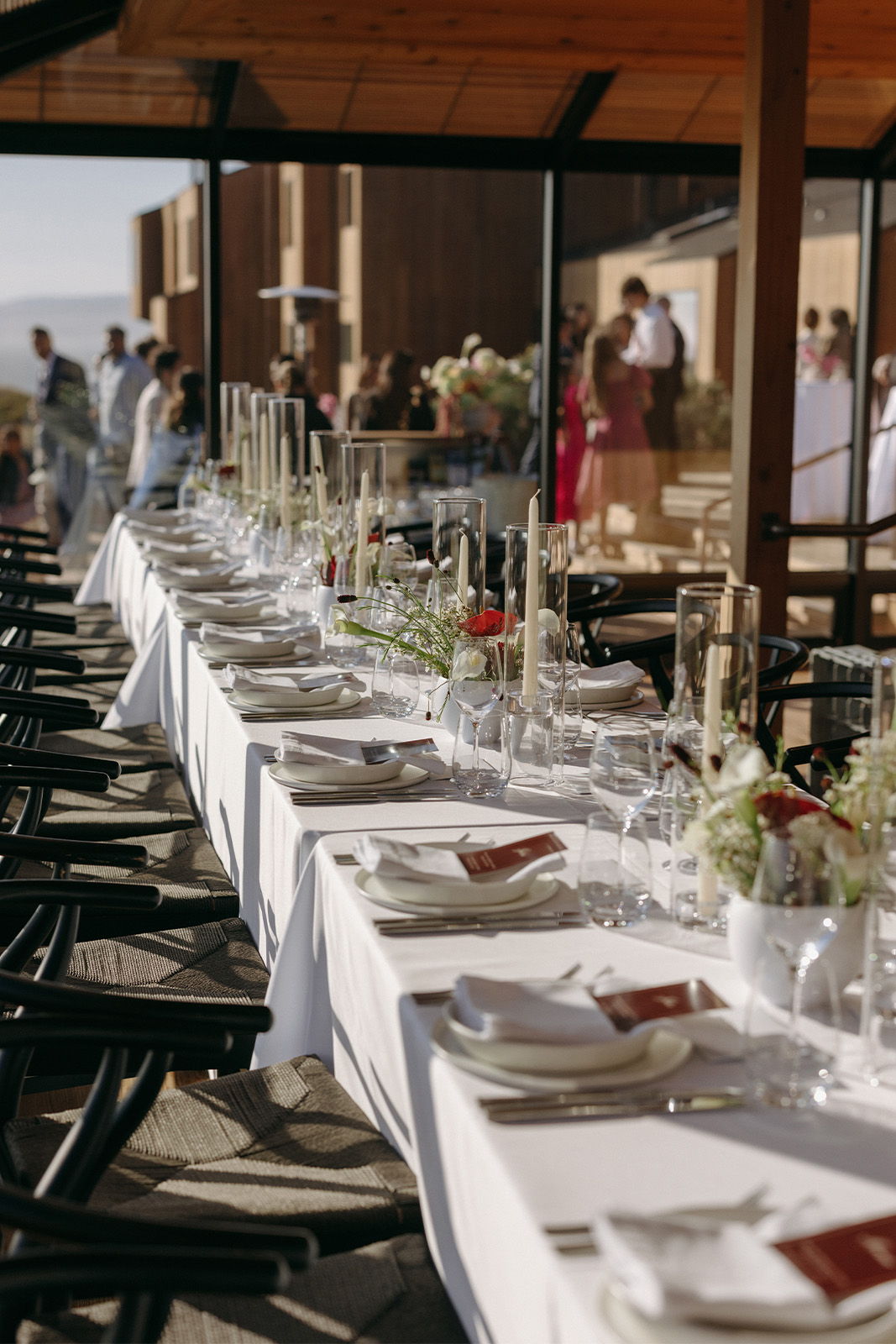 Elegant dining setup with white tablecloths and floral centerpieces.