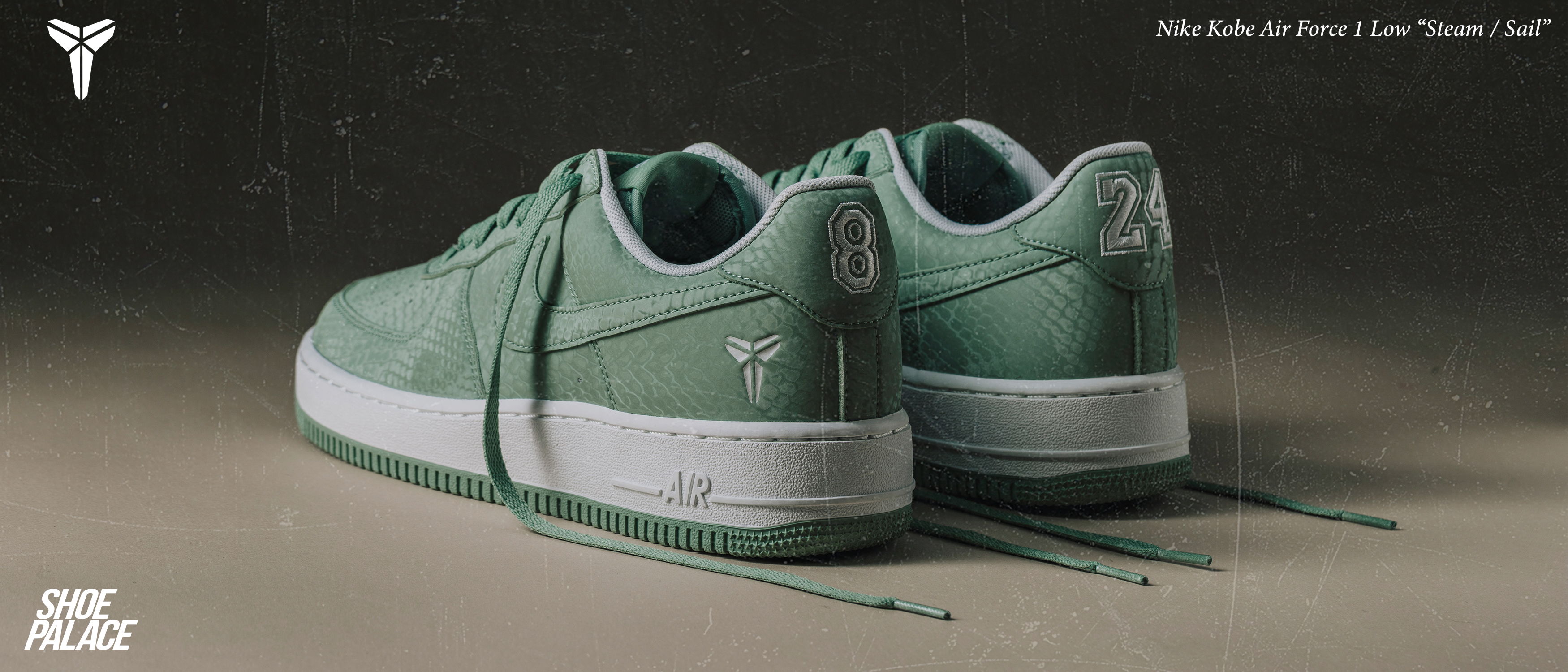 Green Nike sneakers displayed from the back on a neutral background.