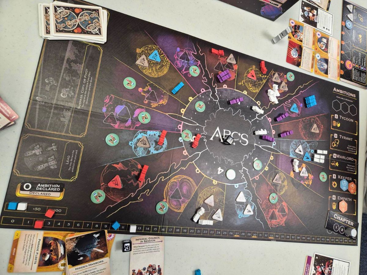 Board game setup with various game pieces and cards displayed.