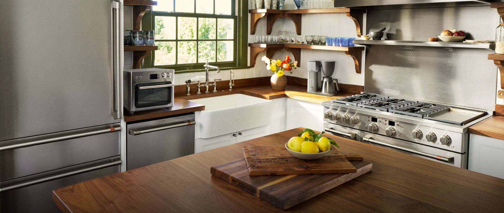 Modern kitchen interior with appliances, wooden counter, and fresh fruit.
