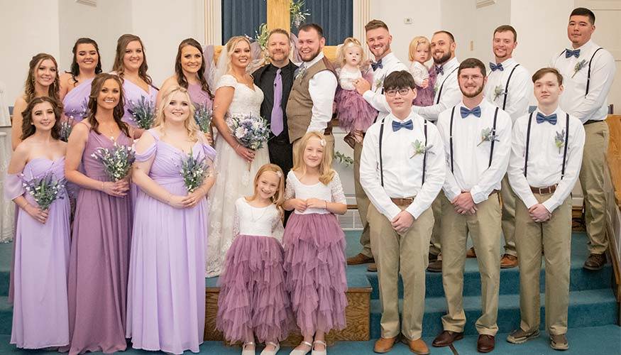 Wedding party wearing dusty blue and lilac purple