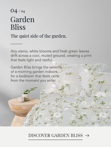 Floral bedding design with green leaves and white blooms, promoting a calming atmosphere.
