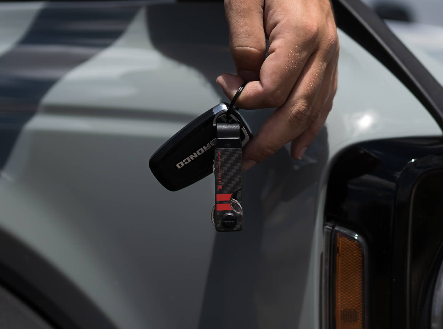 man holding a Ridge Hennessey Performance 22 keycase with dangling car key