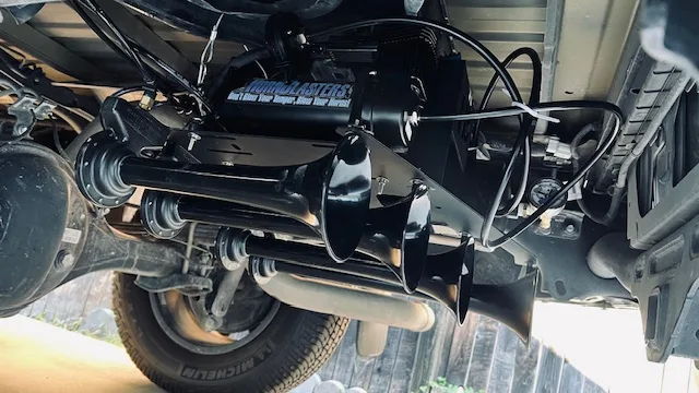 Five black train horns HornBlasters air tank pressure gauge mounted under bed Michelin tire wooden fence Stephen's Conductor's Special 244 Spare Tire Delete featured customer install gallery photo 1