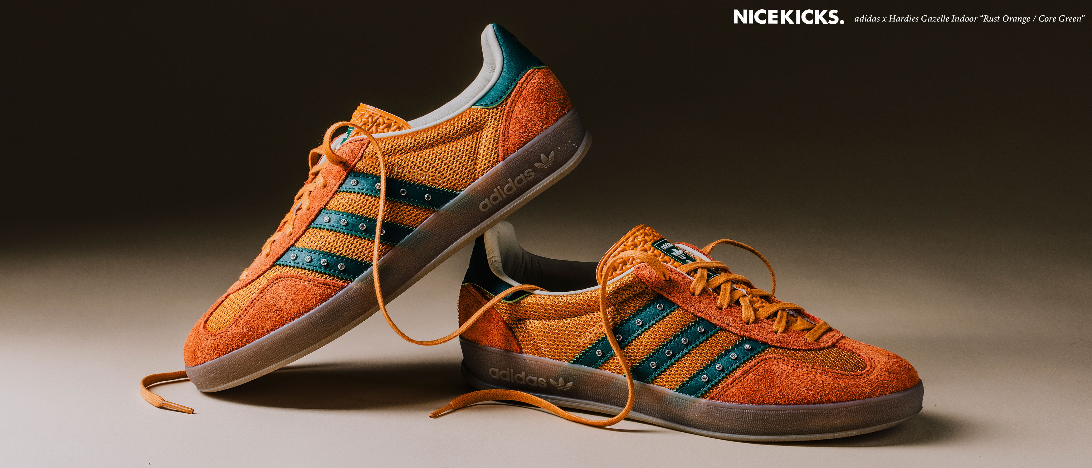 A pair of orange sneakers with blue and yellow accents.