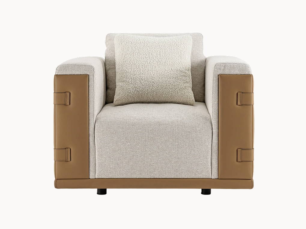 Modern armchair with beige and brown upholstery and a decorative cushion.