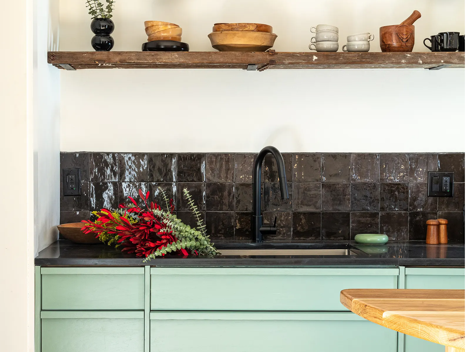 Modern interior design for kitchen, featuring reclaimedkitchen counters custom-built out of salvaged heat-resistant phonetic resin science lab tables.