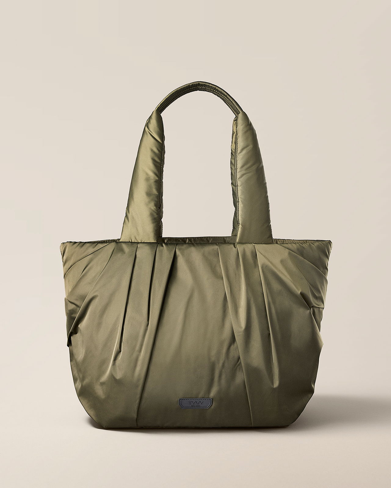 Olive green tote bag with pleated design and two handles.