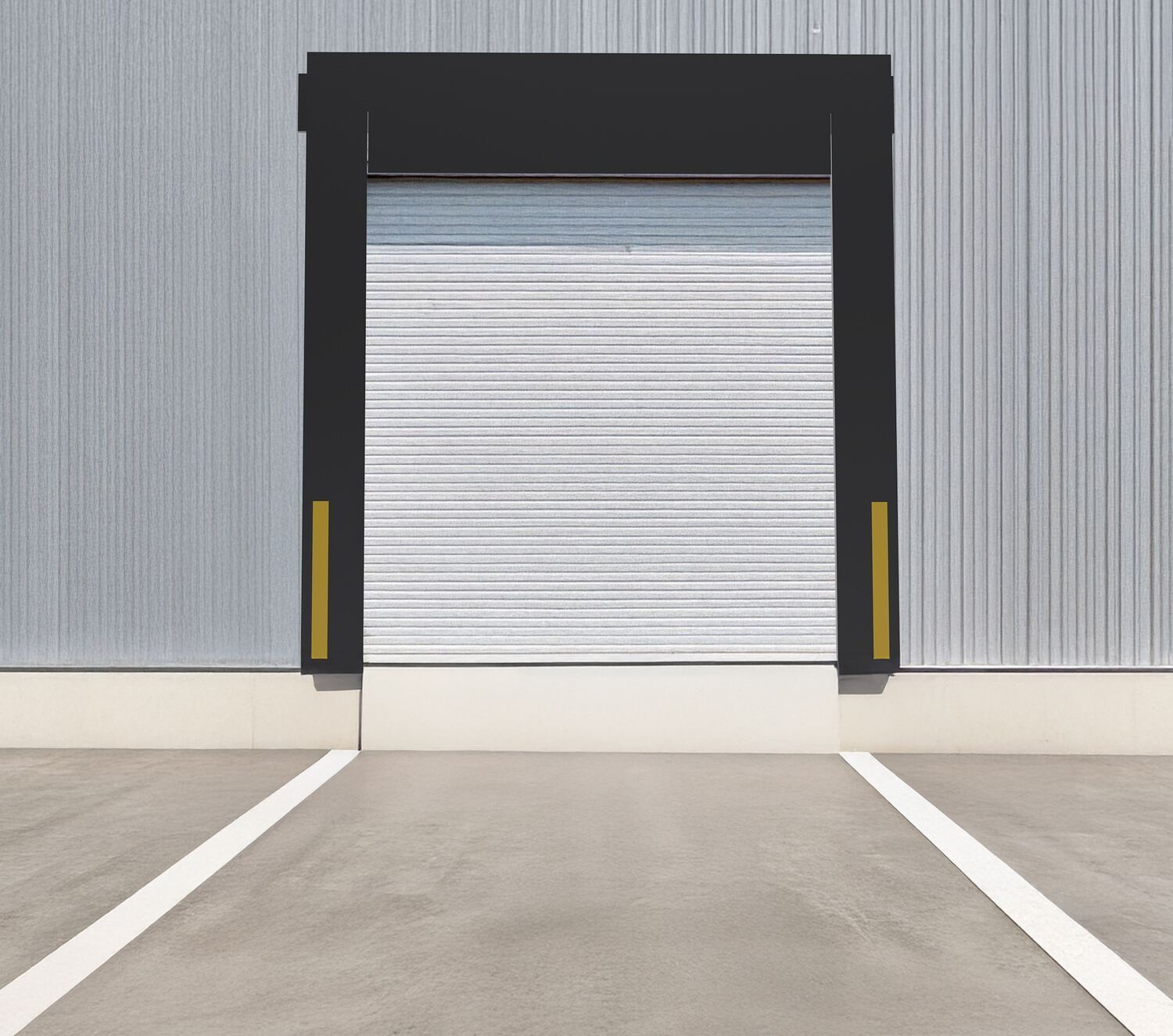 Warehouse loading dock with a closed roll-up door and concrete floor.