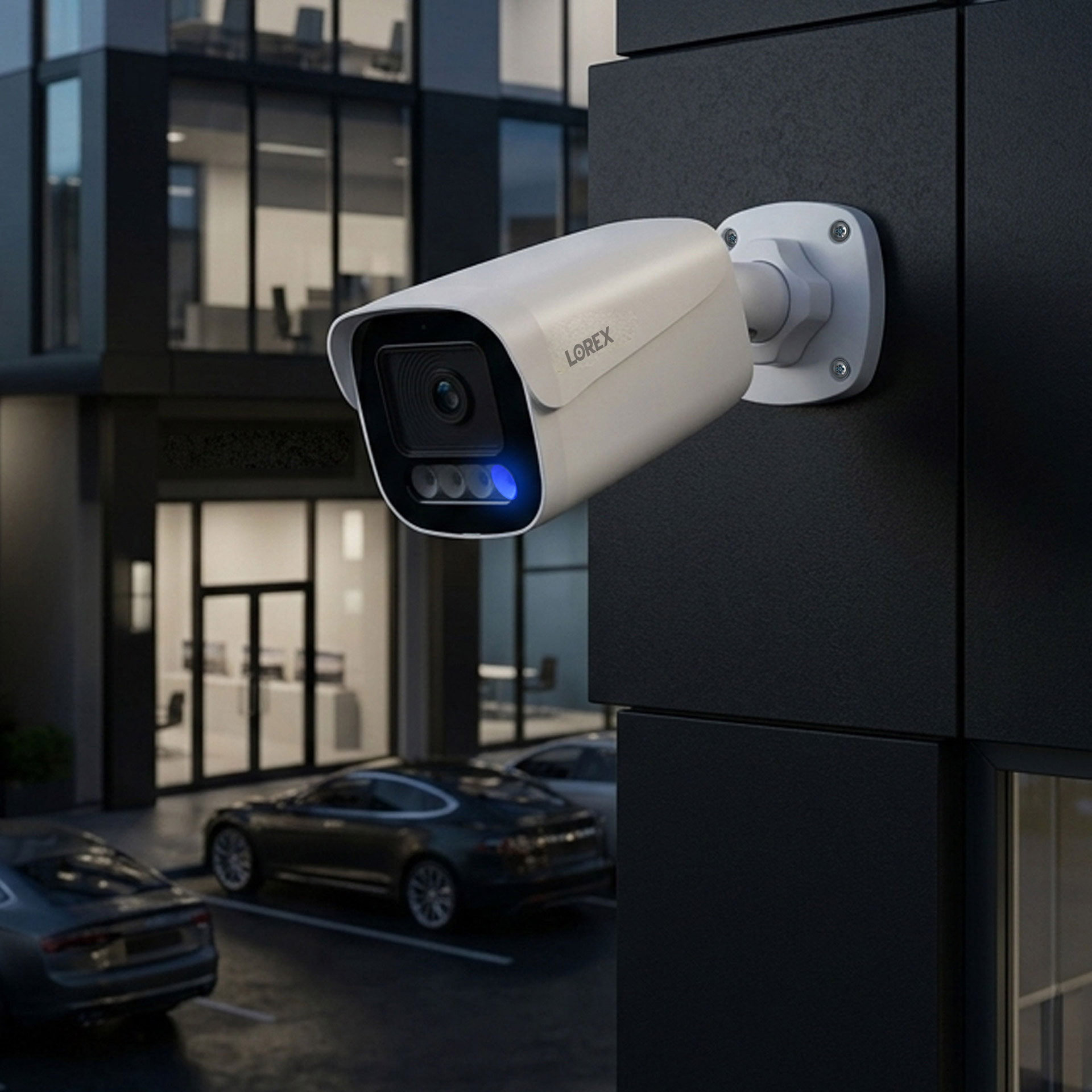 Lorex outdoor security camera mounted on a commercial building monitoring a parking area at night