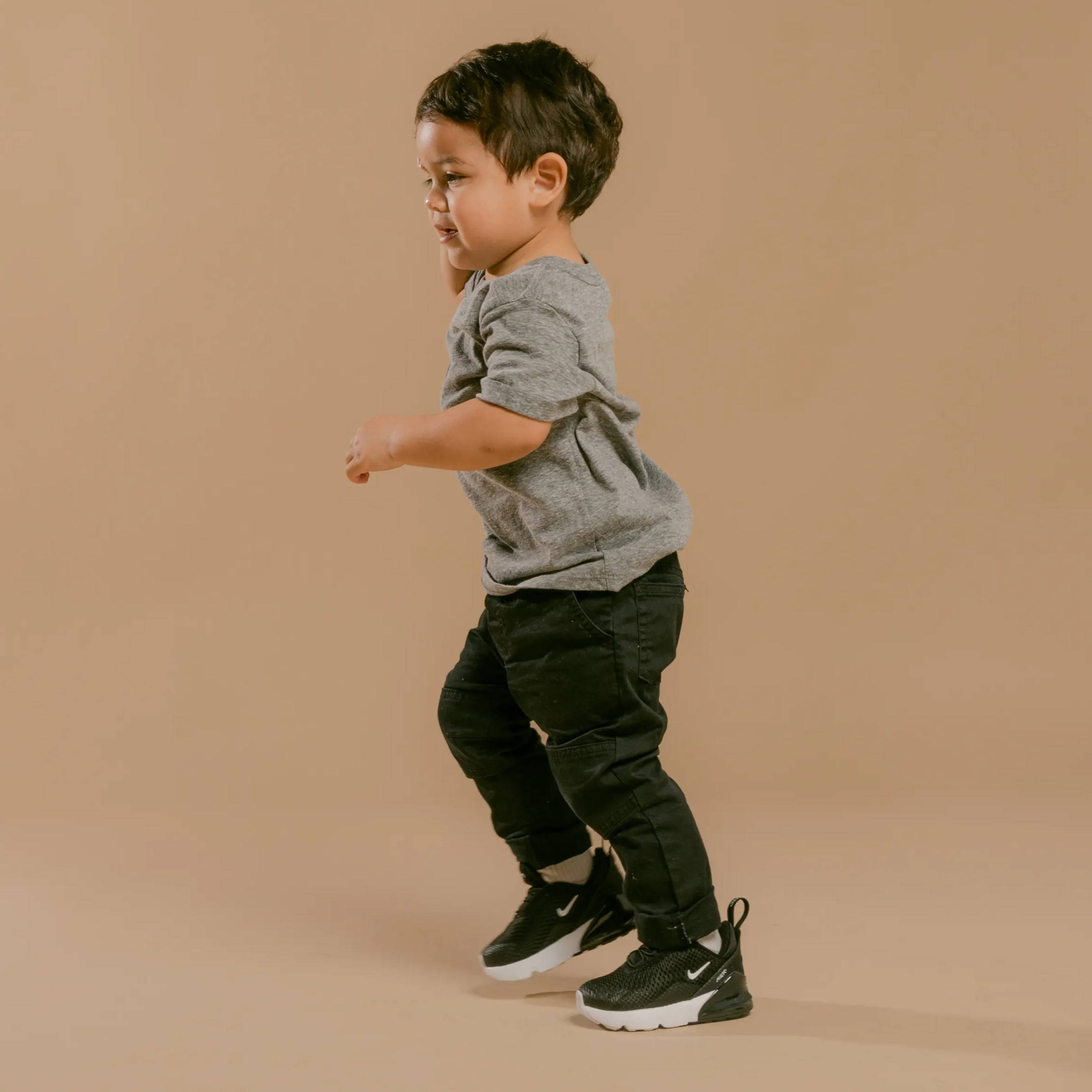 young boy wearing black nike air max shoes