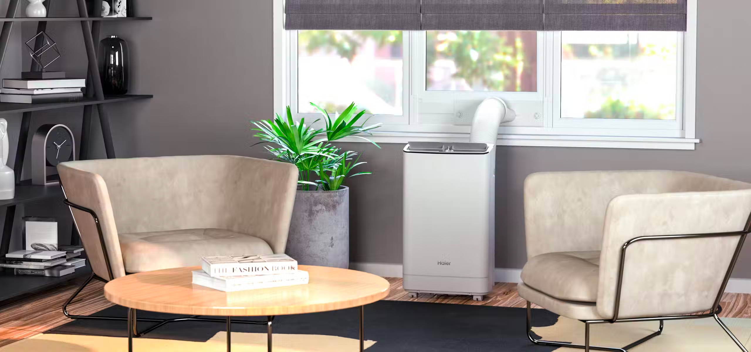 Portable room air conditional positioned near a window in a sitting room. There is a vent connecting the air conditioner to the window.