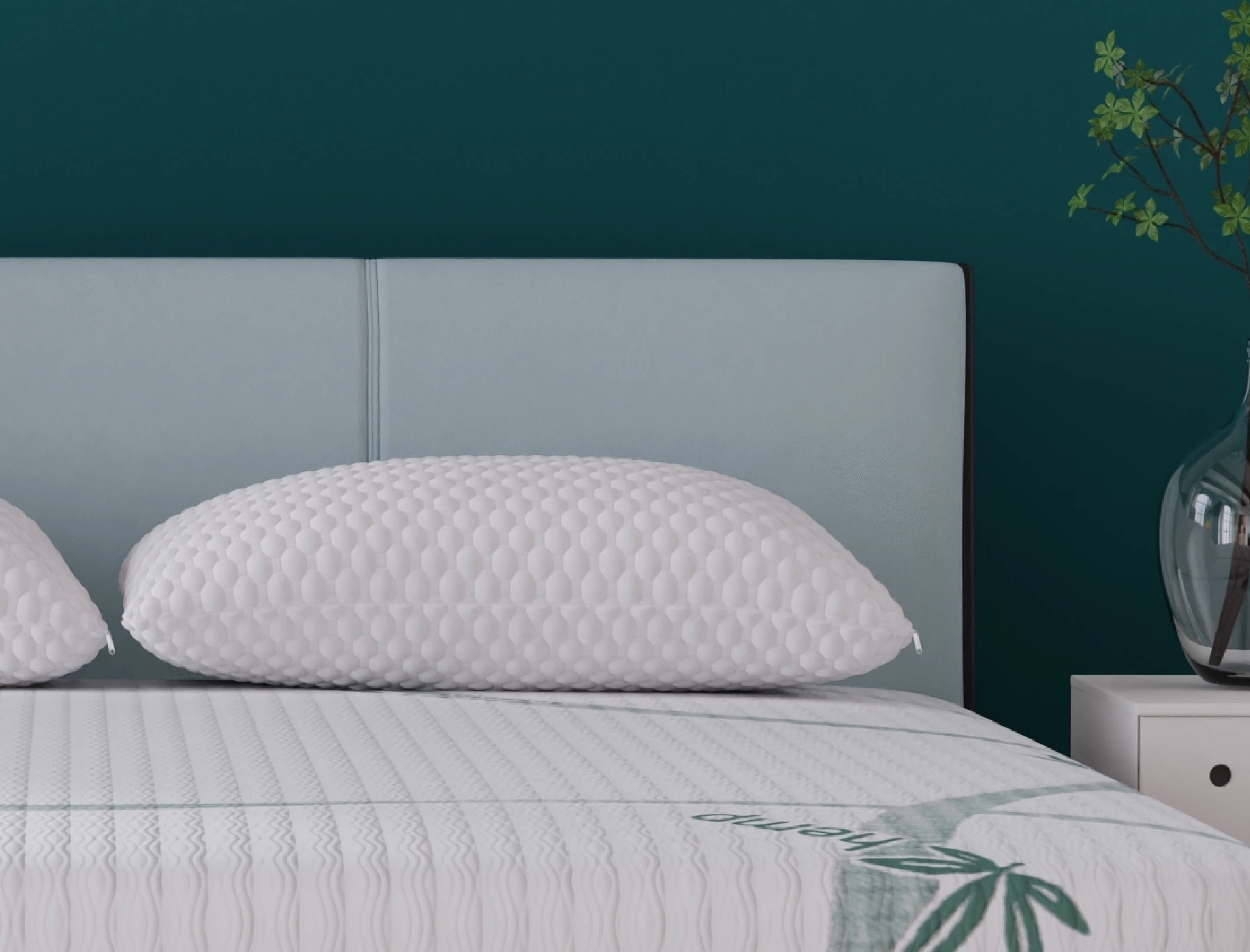 Image of a ZenCloud pillow on the bed with a light blue headboard.