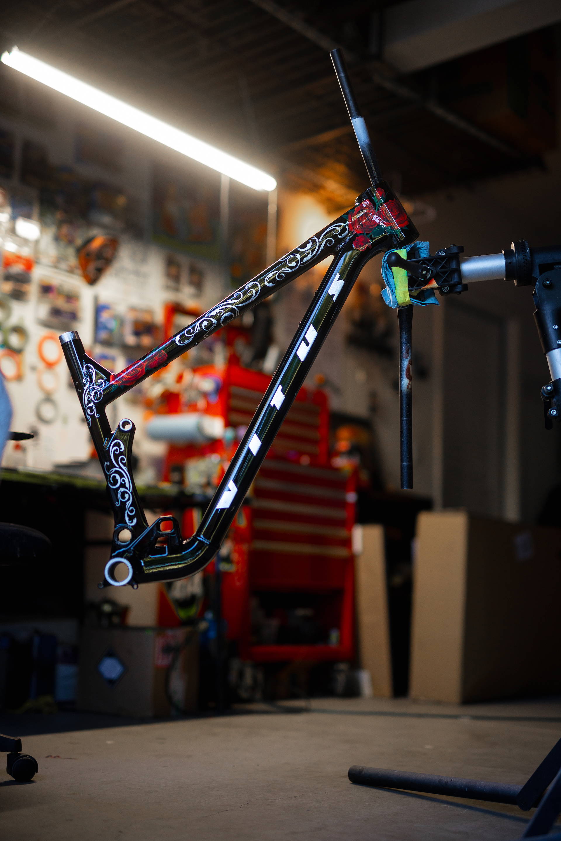Painter Jake Wilkins of Cathedral with Kyle Strait's custom Red Bull Rampage 2023 bike
