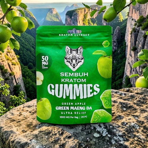 Green apple kratom gummies package against a scenic background of cliffs.