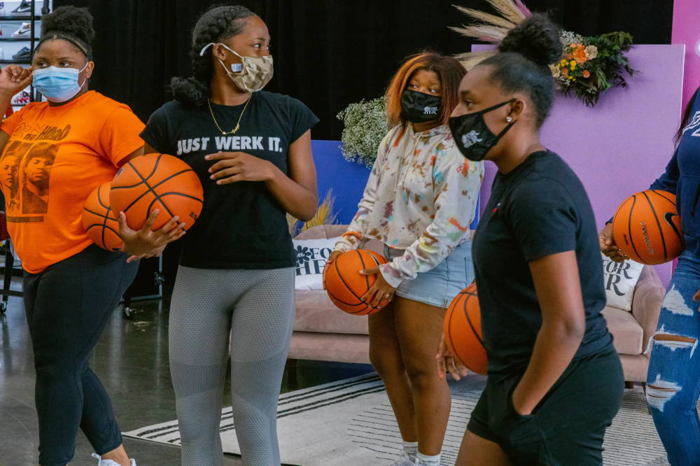 girls holding basketballs at for her event