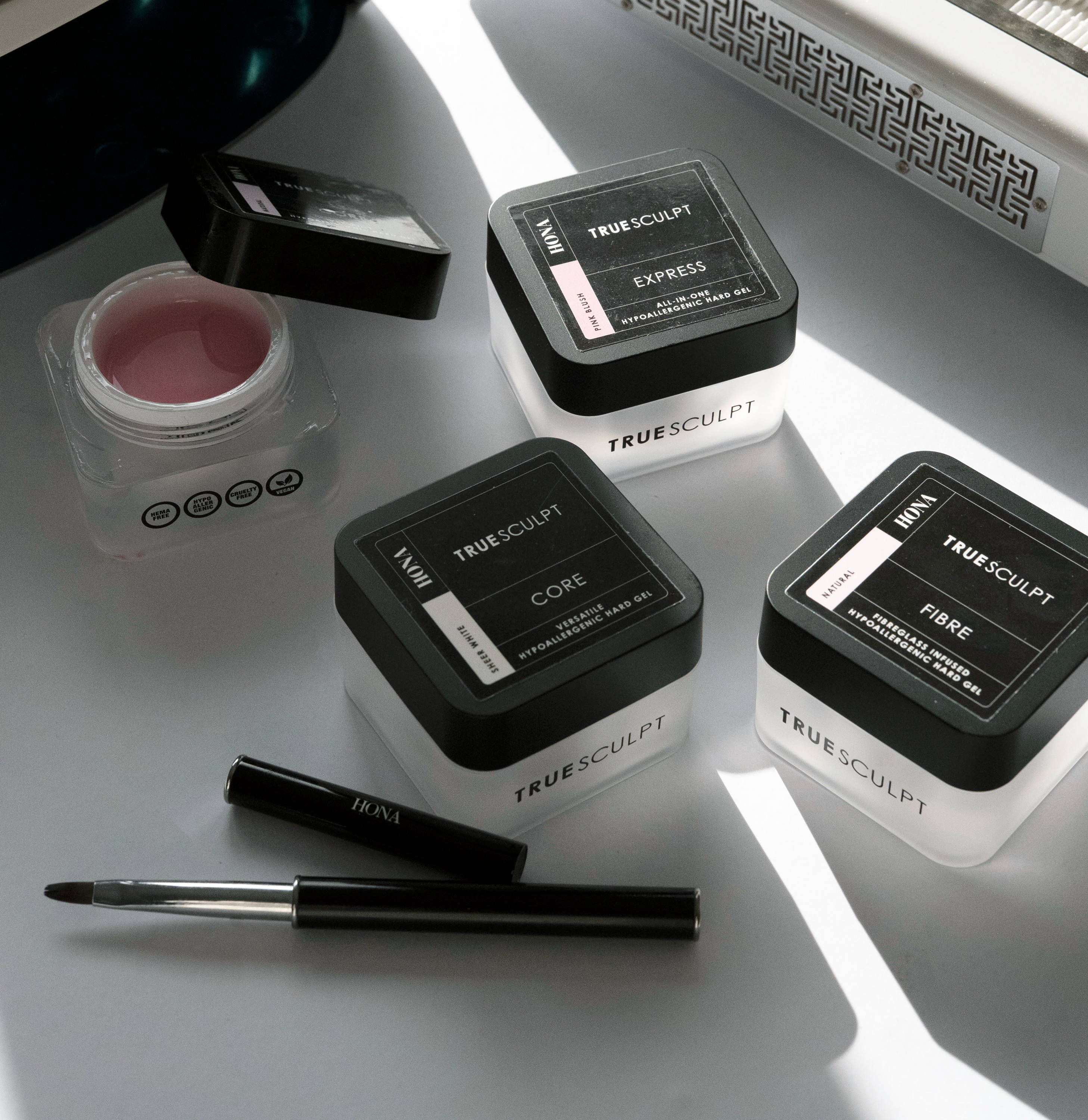 Nail care products and tools on a bright surface.