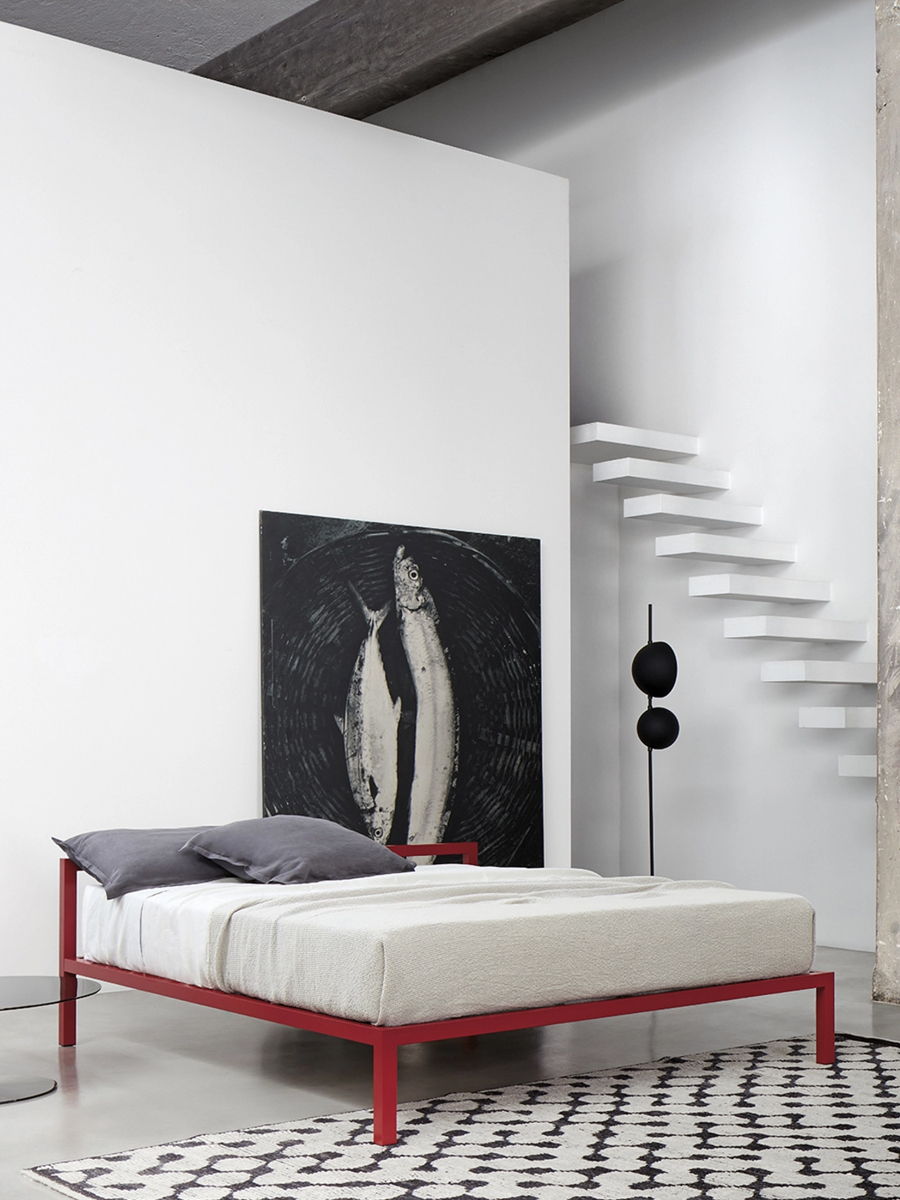 Modern bedroom with a red Aluminium bed frame and abstract fish artwork on the wall.