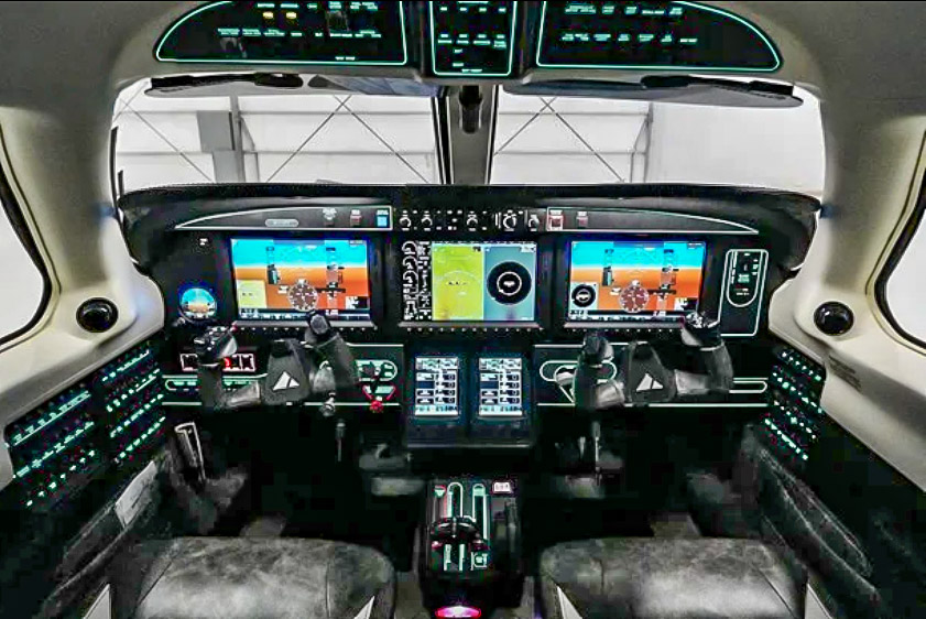Cockpit of an aircraft with digital displays and control panels.