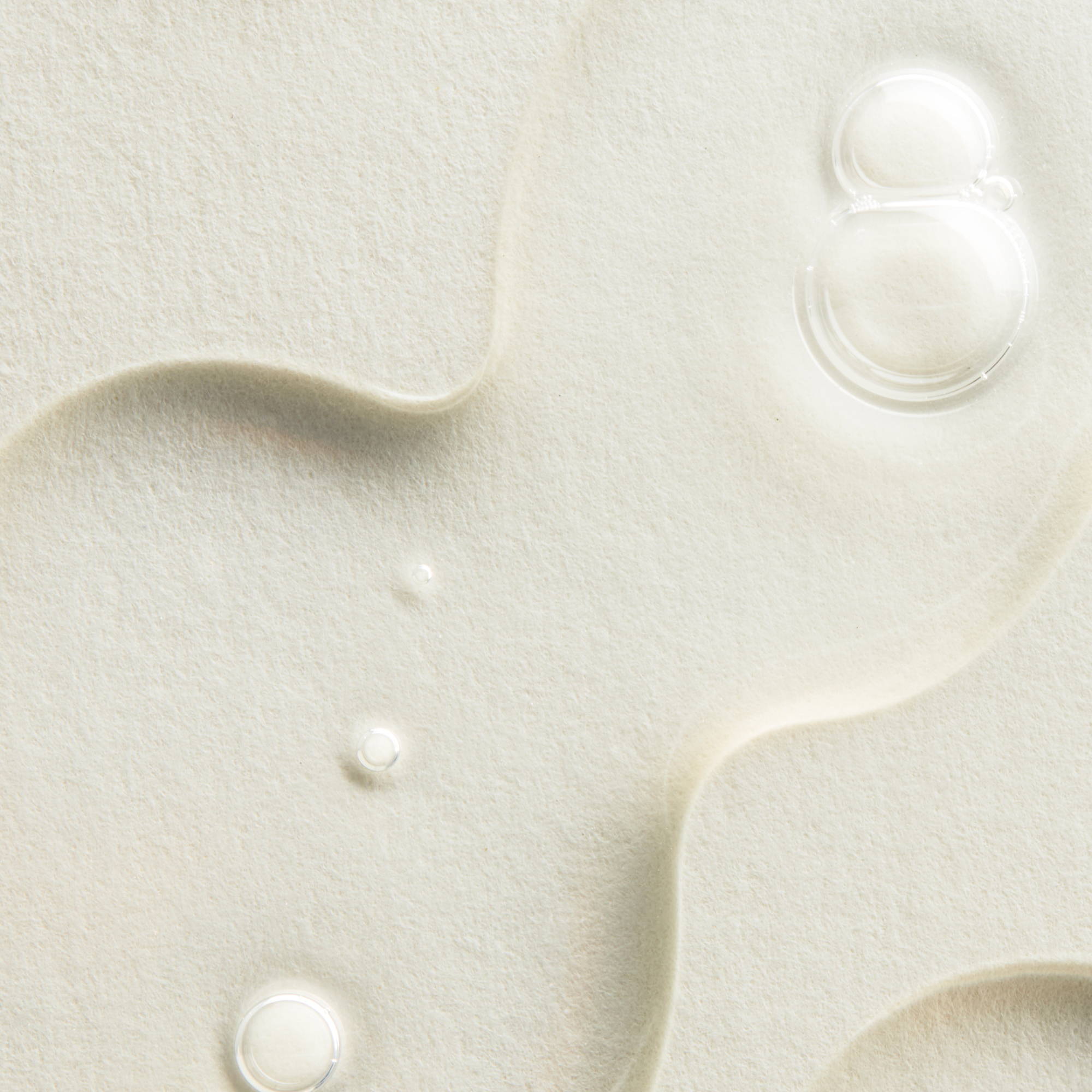 a close up image of droplets of a liquid toner