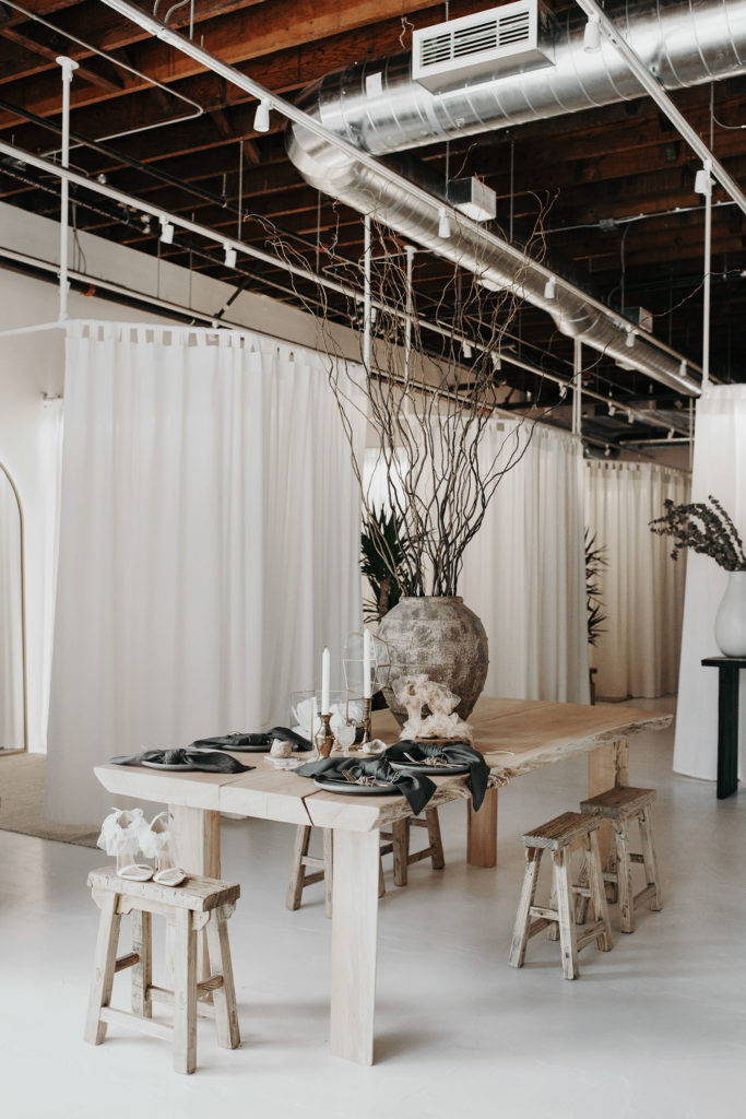 Recycled light timber table and stools in bridal showroom