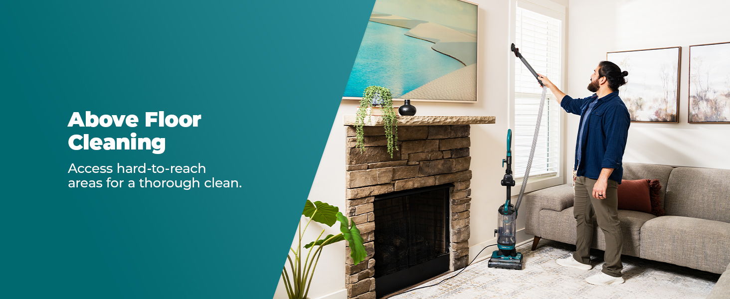 Person using a vacuum cleaner for above floor cleaning in a living room.